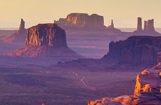 A view of tall buttes in the desert.
